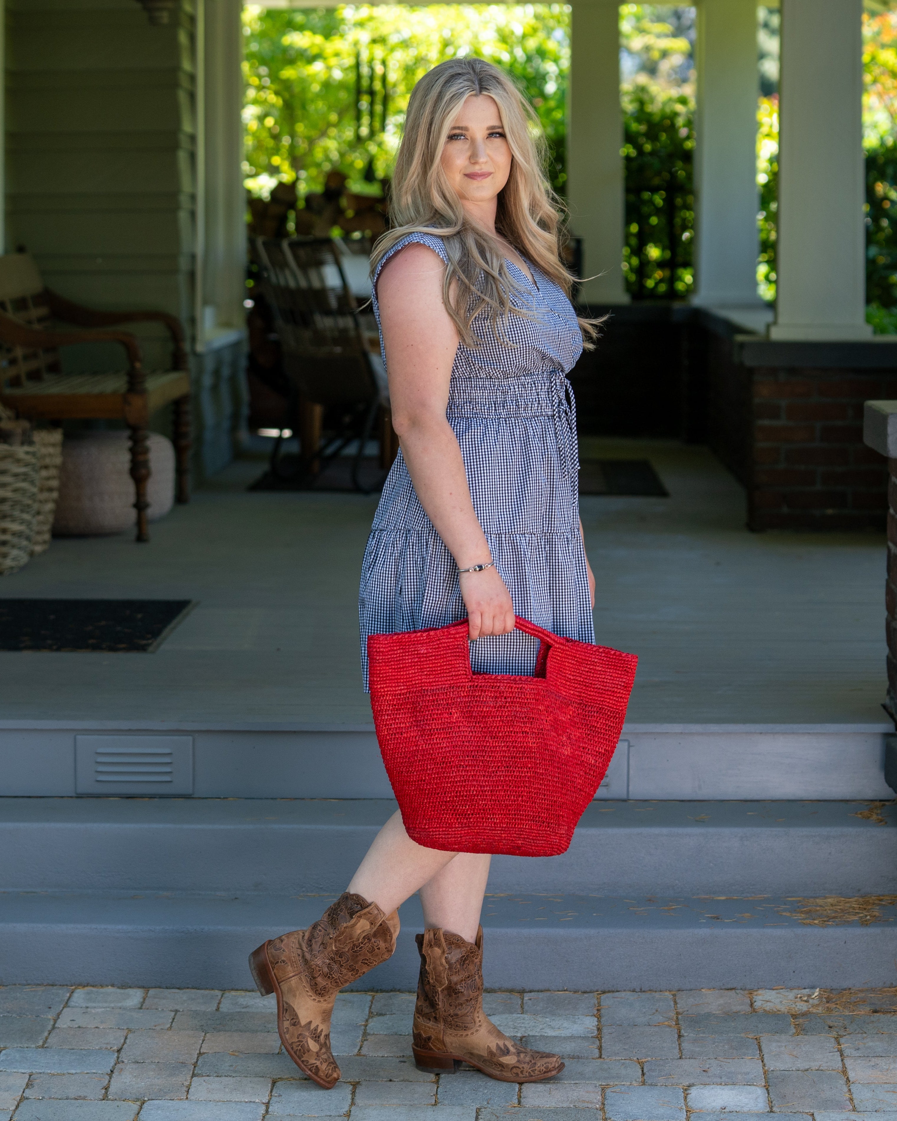 Model wearing ConCon Crochet Straw Basket handmade woven raffia palm fiber in a solid hue of red making a textured link pattern handbag tote - Shebobo