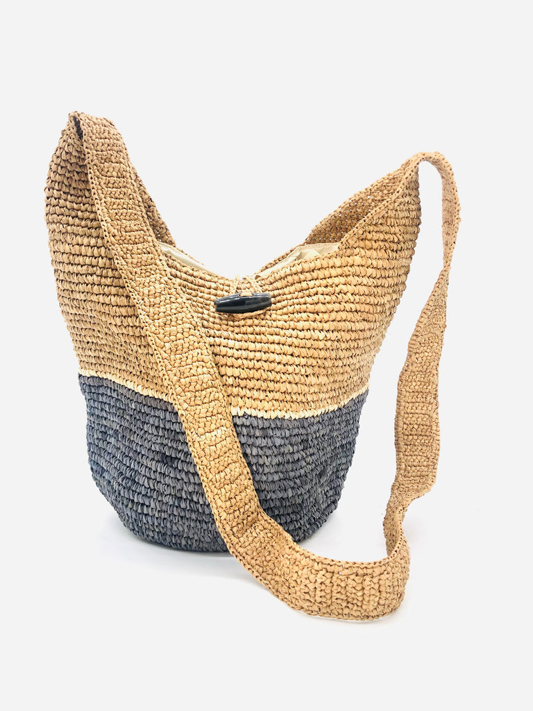 ConCon Two Tone Crochet Crossbody Bag handmade with interior liner, horn button and loop closure raffia purse grey bottom, with narrow natural straw color horizontal stripe separating light brown/tea colored top & shoulder strap - Shebobo