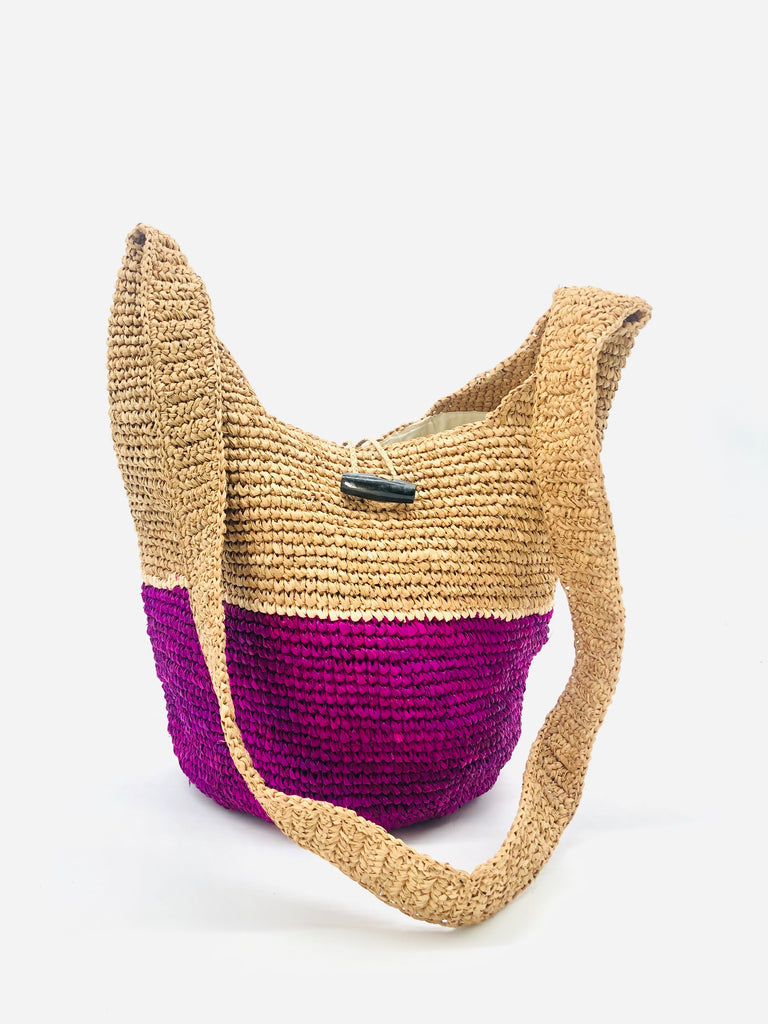ConCon Two Tone Crochet Crossbody Bag handmade with interior liner, horn button and loop closure raffia purse orchid purple bottom, with narrow natural straw color horizontal stripe separating light brown/tea colored top & shoulder strap - Shebobo