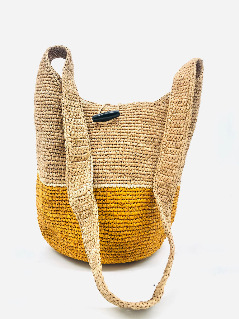 ConCon Two Tone Crochet Crossbody Bag handmade with interior liner, horn button and loop closure raffia purse saffron/yellow bottom, with narrow natural straw color horizontal stripe separating light brown/tea colored top & shoulder strap - Shebobo