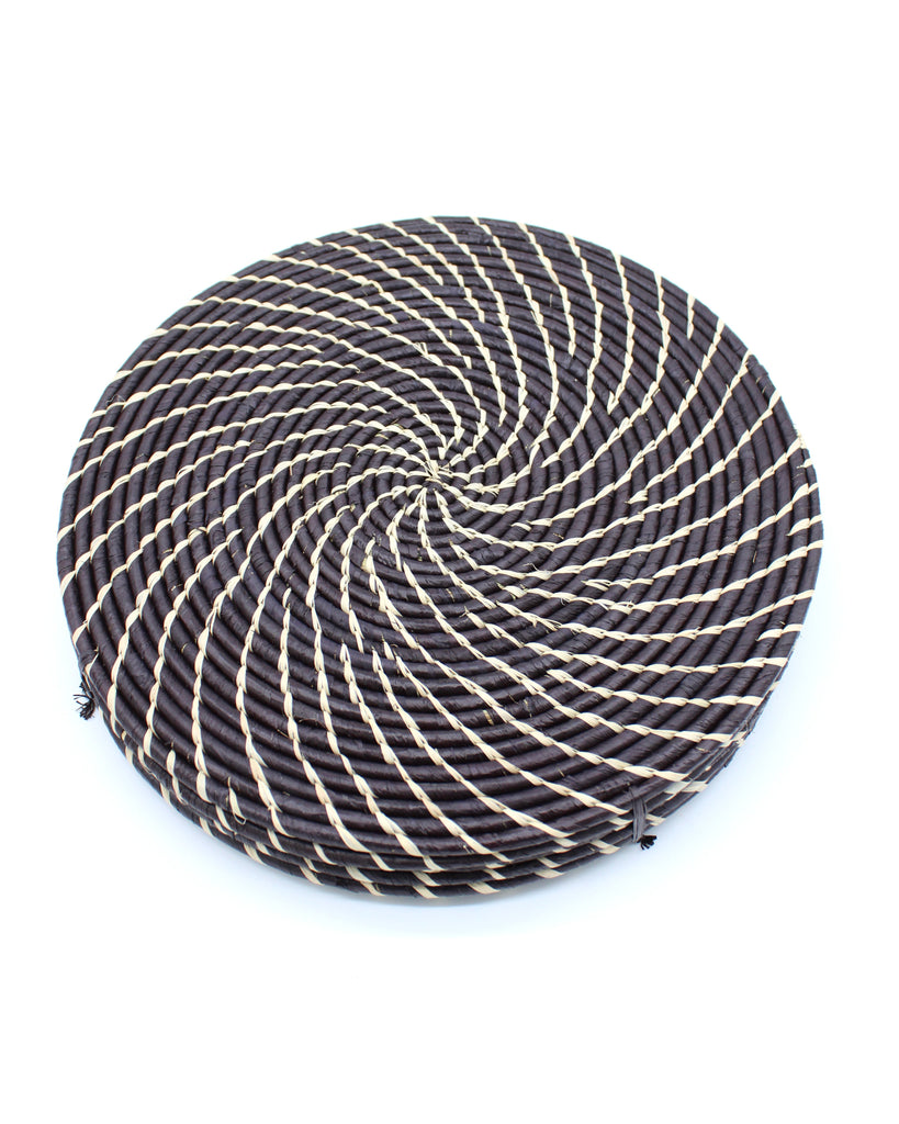 Dabu Round Two Tone Swirl Raffia Straw Coasters & Placemats Set of 6 handmade natural raffia palm fiber in a crochet loop disc technique creating concentric circular stripe pattern of texture in a solid hue of black with contrasting knotted spiral swirl weave in natural straw color sets of six placemats or coasters - Shebobo