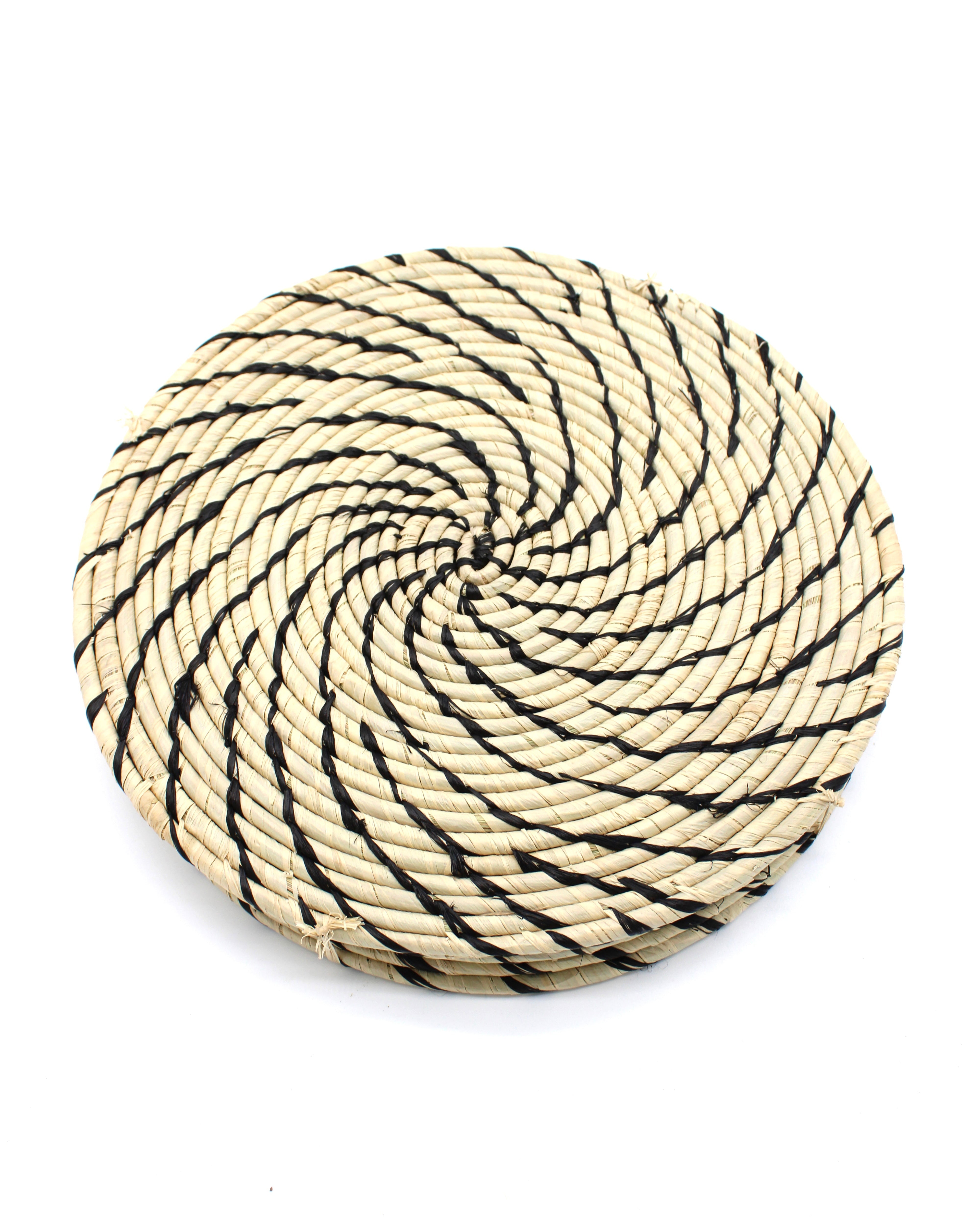 Dabu Round Two Tone Swirl Raffia Straw Coasters & Placemats Set of 6 handmade natural raffia palm fiber in a crochet loop disc technique creating concentric circular stripe pattern of texture in a solid hue of natural straw color with contrasting knotted spiral swirl weave in black sets of six placemats or coasters - Shebobo