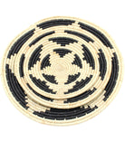 Detail view Dakarai Raffia Straw Wall Decor Display Basket Tray: Set of 3 handmade woven natural raffia palm fiber in a crochet loop technique concentric coiled circular pattern with double natural straw color and black centered star flower pattern set of three sized flat bowl trays - Shebobo