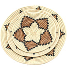 Detail view Dakarai Raffia Straw Wall Decor Display Basket Tray: Set of 3 handmade woven natural raffia palm fiber in a crochet loop technique concentric coiled circular pattern with double natural straw color, cinnamon/tobacco/brown, and black centered star flower pattern set of three sized flat bowl trays - Shebobo