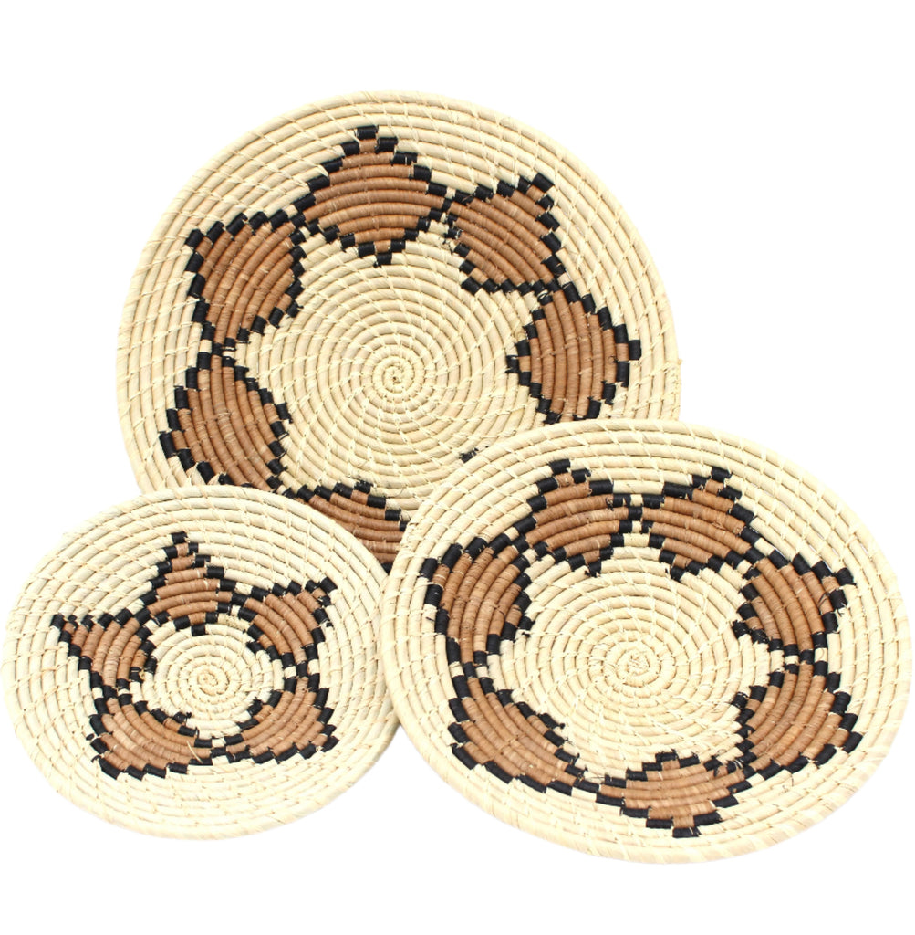 Dakarai Raffia Straw Wall Decor Display Basket Tray: Set of 3 handmade woven natural raffia palm fiber in a crochet loop technique concentric coiled circular pattern with double natural straw color, cinnamon/tobacco/brown, and black centered star flower pattern set of three sized flat bowl trays - Shebobo