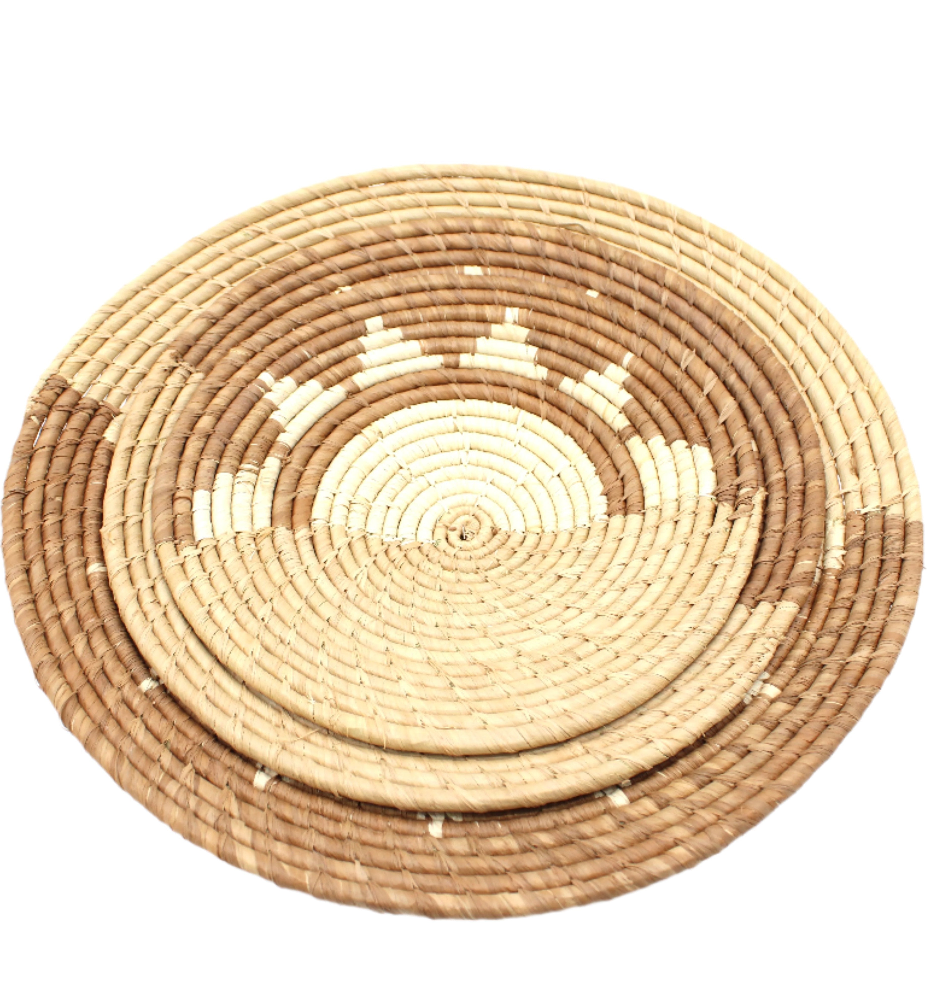 Detail view Dakarai Raffia Straw Wall Decor Display Basket Trays: Set of 3 handmade woven raffia palm fiber in a crochet loop technique creating a concentric swirl pattern of bands of  cinnamon/tobacco/brown, cappuccino/tea/light brown, and natural straw color that create a two tone pattern with half of the disc being light brown, and the other half a sun burst pattern set of three sized flat bowl trays - Shebobo