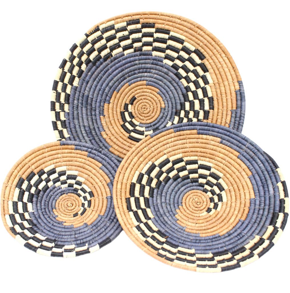 Dakarai Raffia Straw Wall Decor Display Basket Trays: Set of 3 handmade woven raffia palm fiber in a crochet loop technique creating a concentric swirl pattern of bands of  cinnamon/tobacco/brown, grey, and black and natural straw color checked pattern in a three tone spiral from the center to the outer edge set of three sized flat bowl trays - Shebobo
