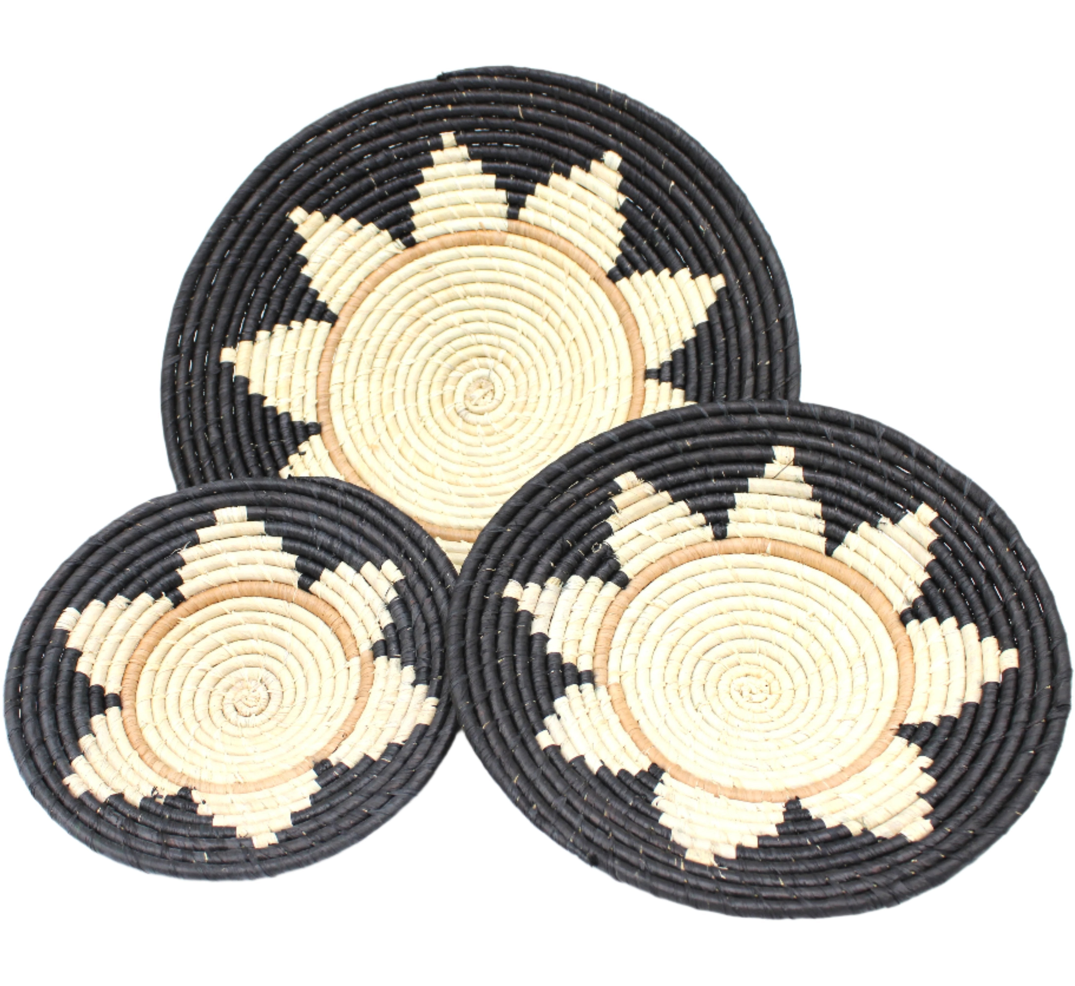 Dakarai Raffia Straw Wall Decor Display Basket Tray: Set of 3 handmade woven natural raffia palm fiber in a crochet loop technique concentric coiled circular pattern with centered natural straw color and brown circling ring and natural sunburst floral design pattern up the otherwise black sides of the disc set of three sized flat bowl trays - Shebobo