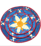 Detail view Dakarai Raffia Straw Wall Decor Display Basket Tray: Set of 3 handmade woven natural raffia palm fiber in a crochet loop technique concentric coiled circular pattern with natural straw color, saffron orange/yellow, blue, and red centered star flower pattern set of three sized flat bowl trays - Shebobo