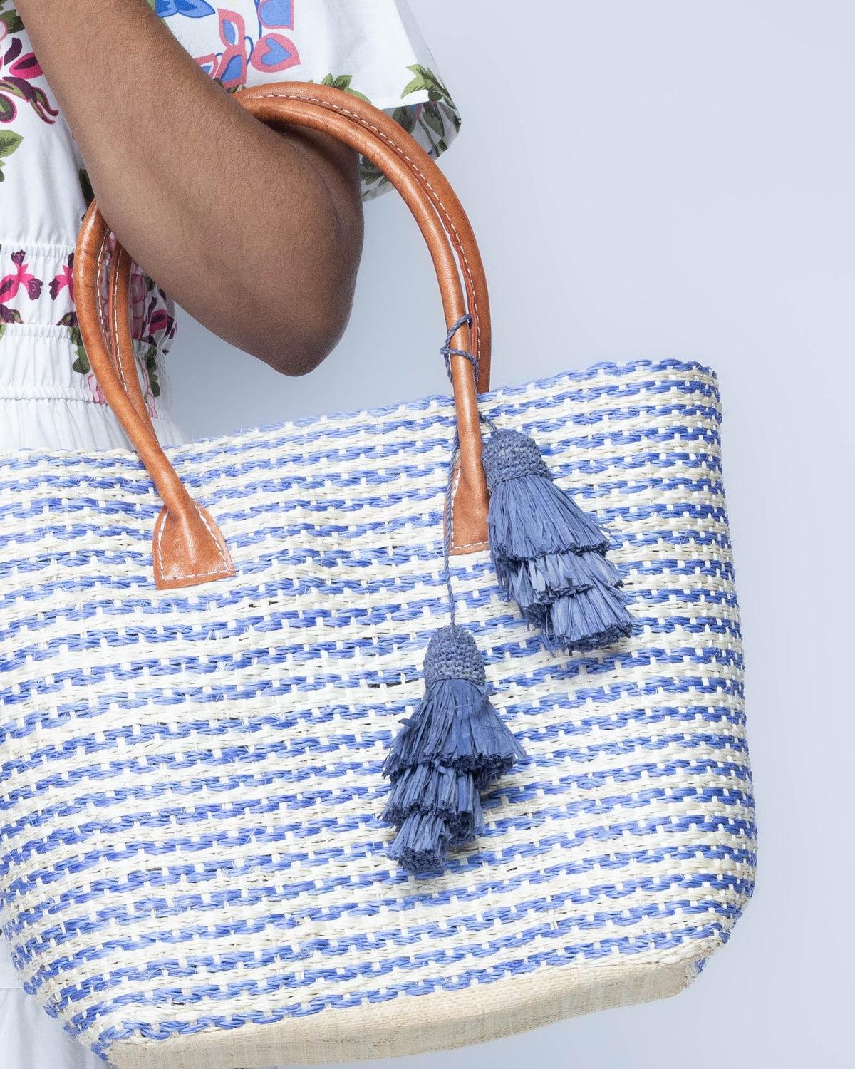 Model wearing Tassel Tie Two Layered Raffia Straw Tiered Tufts Charm Embellishment handmade crochet and brushed natural raffia palm fiber in a single hue layered tuft tassel of Denim light/retro/blue beach bag handbag charm embellishment or party decor - Shebobo