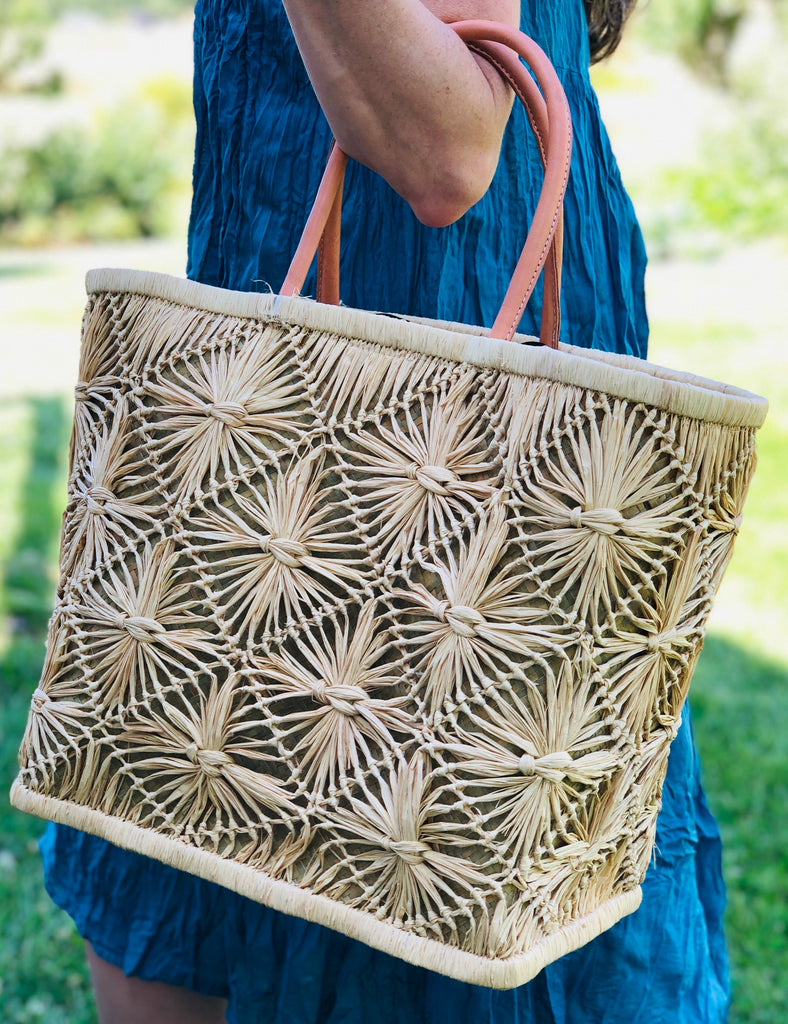 Model with Macrame Diamond Straw Basket Bag Handmade knotted natural raffia palm fiber in a geometric diamond pattern handbag with leather handles - Shebobo