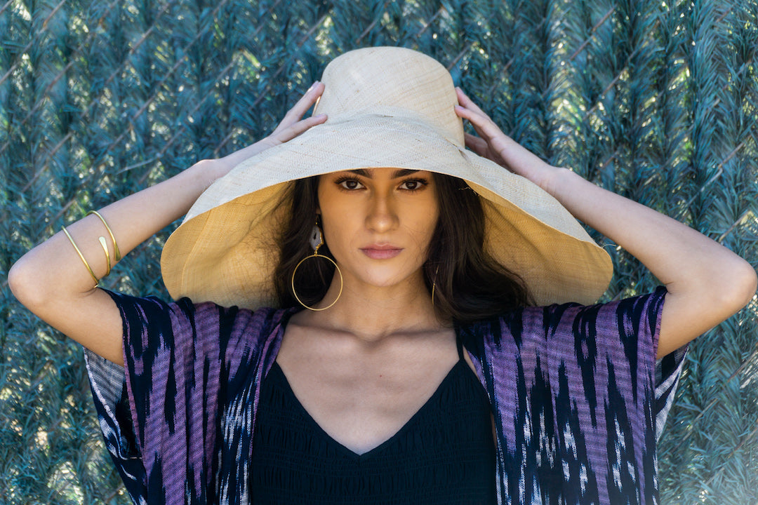 Model wearing Estrella 7 inch wide floppy brim handmade loomed raffia palm fiber natural straw color packable lightweight straw hat - Shebobo