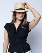 Model wearing Fedra 2" Brim Fedora Unisex Straw Hats natural and black pinstripes packable raffia straw hat handmade loomed raffia in wide bands of natural straw color with black narrow bands create a stripe swirl pattern - Shebobo