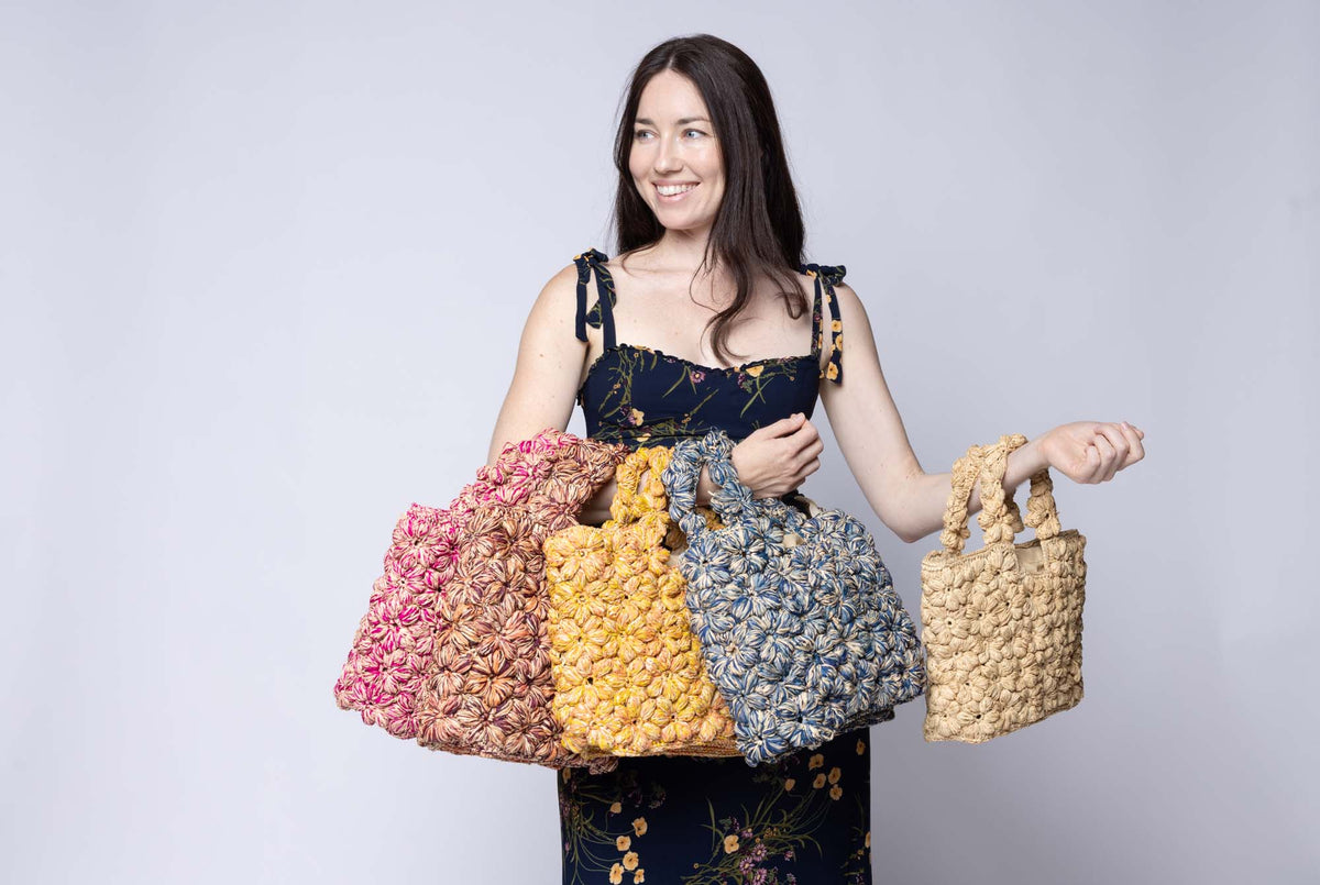 Model wearing Florence Flower Crochet Raffia Straw Basket Handbag in multiple color options - Shebobo
