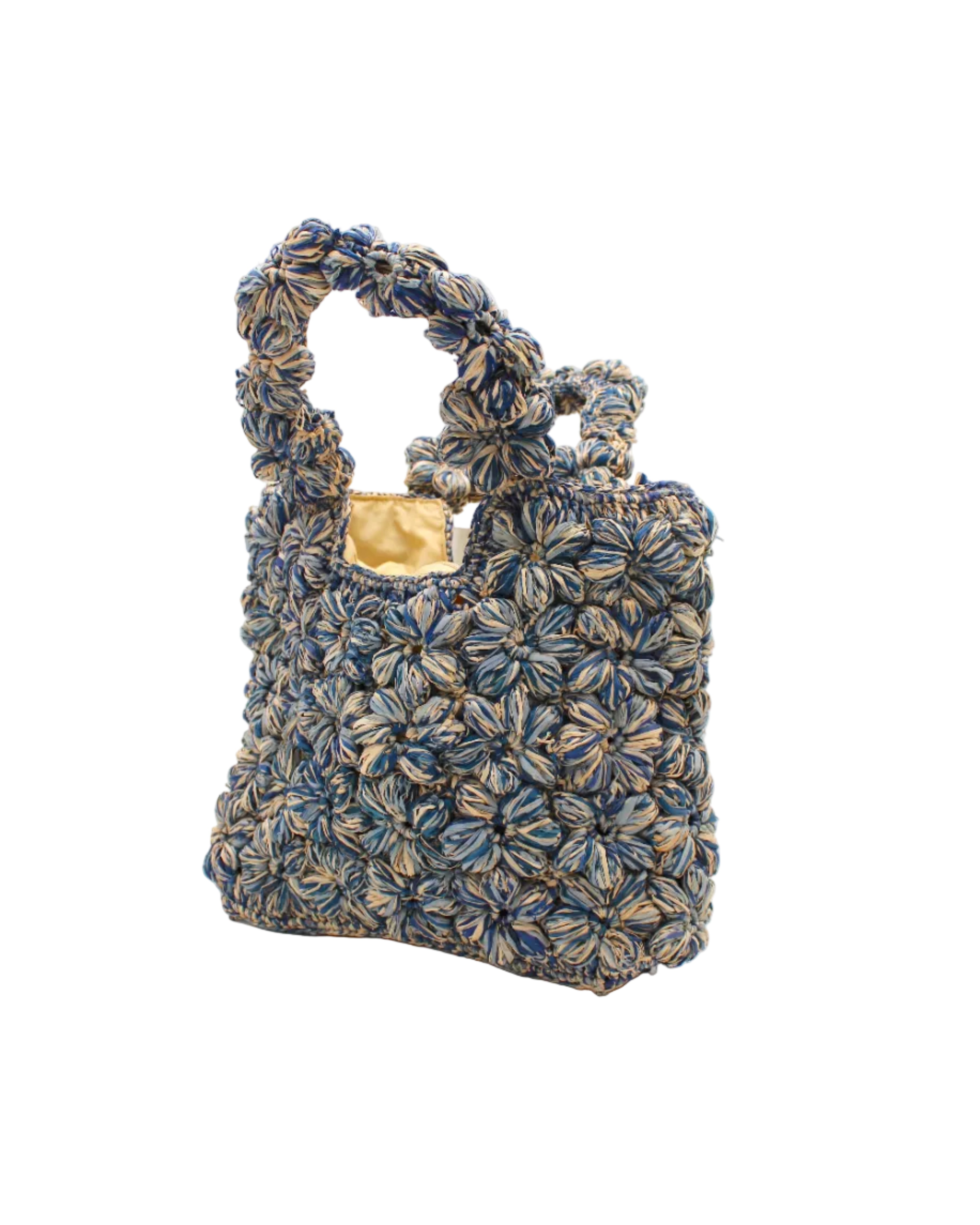 Side view Florence Denim Blues Multicolor Flower Crochet Straw Basket Handbag handmade natural raffia palm fiber in a multicolor hue combination of natural straw color, denim light/retro/blue, and luminous navy/dark/blue with subtle tied flower design consisting of 88 flowers crochet together along the outside of the bag as well as the handles purse tote - Shebobo