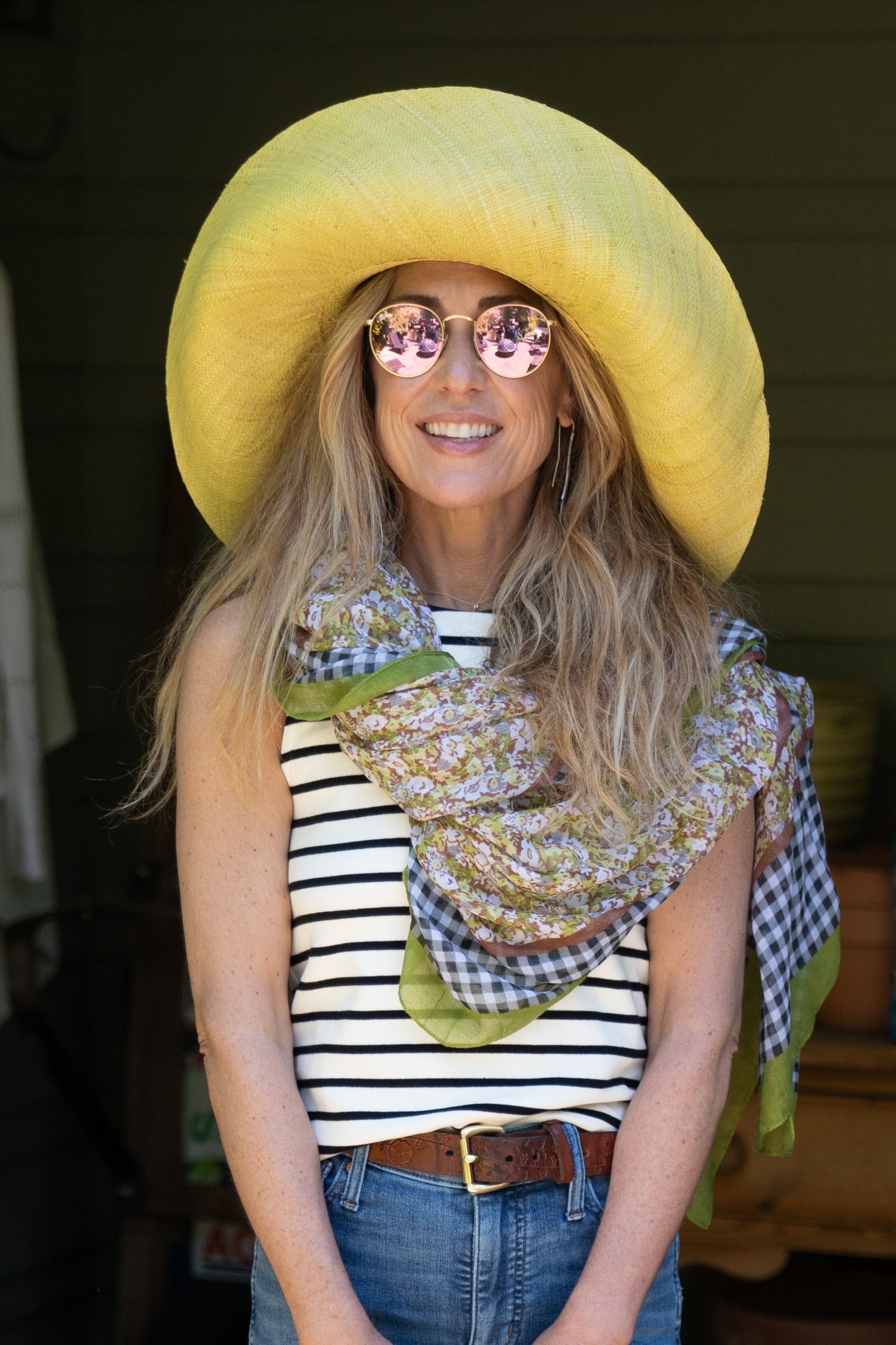 Model wearing French Country Floral and Gingham Scarf Wrap Green Multicolor Floral pattern inside a black and white checked gingham plaid with colored edge - Shebobo (with 7" Packable Butter Straw Sun Hat, Boucle Basket Bag, and Lizzie Sandal)