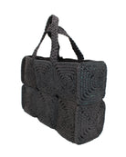 Side view Gemma Crochet Disc Rectangle Large Straw Basket Handbag handmade braided natural raffia palm fiber in a solid hue of Black with subtle square disc pattern around the outside of the bag in two horizontal bands of squares creating a geometric pattern and matching woven handles beach bag purse - Shebobo