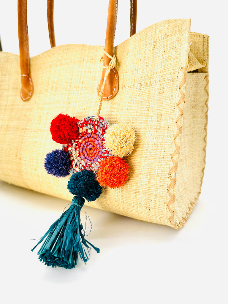 Habiba Natural Straw Handbag with multicolor (red, blue, turquoise, coral, natural, grey, and purple) Pomom & Tassel Crochet Dreamcatcher Bag Charm Embellishment handmade loomed raffia purse with leather handles and zipper closure - Shebobo