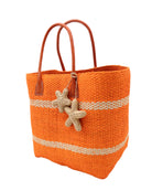 Side view Havana Sisal Basket Bag with Tassel Charm Embellishment handmade sisal fiber woven into horizontal wide bands of coral orange with two evenly spaced narrow bands of natural straw color create a stripe pattern with natural crochet starfish charm embellishment and leather handles handbag shoulder bag - Shebobo