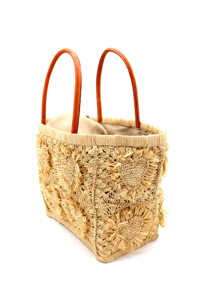 Side View Hearts Crochet Straw Basket Bag with Fringed Heart Pattern handmade woven raffia in a solid hue of natural straw color with granny square pattern and raised/stuffed heart pattern with fringe edges on each heart, looped base and top binding, as well as leather handles purse beach bag shoulder bag - Shebobo 