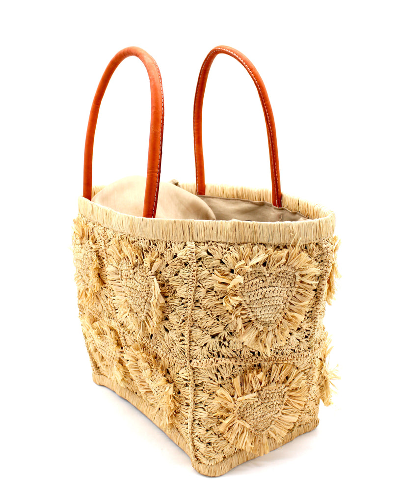Side View Hearts Crochet Straw Basket Bag with Fringed Heart Pattern handmade woven raffia in a solid hue of natural straw color with granny square pattern and raised/stuffed heart pattern with fringe edges on each heart, looped base and top binding, as well as leather handles purse beach bag shoulder bag - Shebobo 