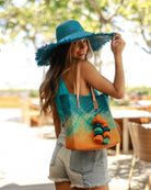 Model wearing Holden Ombre Turquoise Straw Handbag Tassel Charm Embellishment handmade woven raffia dip dyed gradient of turquoise blue, seafoam blue/green, and saffron yellow with matching multicolored, multi-tiered raffia tuft tassel - Shebobo (with 5" Brim Kat Turquoise Straw Hat)