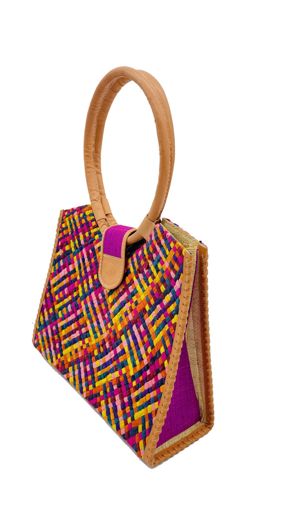Side view Ibiza Raspberry Multi Straw HandBag with Leather Handles handmade woven natural raffia fiber purse with multicolor yellow, orange, pink, fuchsia, bordeaux, blue, turquoise, etc. crosshatch pattern and loomed sides with leather loop handles, woven leather side seam binding, and flap closure - Shebobo