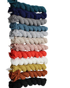 Isla Solid Color Cotton Scarf Wrap showing all color ways of teal, dusk blue, grey, denim blue, sky, natural, rose petal, coral, white, cumin, whisky, and black - Shebobo