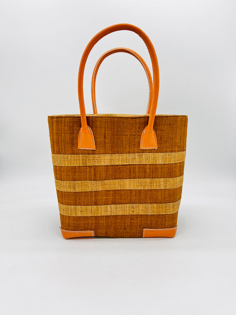 Jacky Cinnamon Small Straw Basket Bag handmade loomed raffia palm fiber in brown with three centered horizontal stripes of lighter tobacco/cinnamon/brown handbag purse with leather handles and detailing - Shebobo
