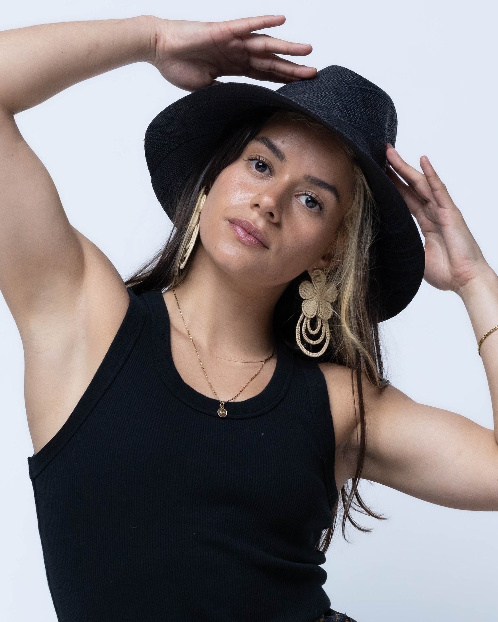 Model wearing Panama black unisex straw hat handmade 3" brim loomed raffia black travel hat sun hat - Shebobo