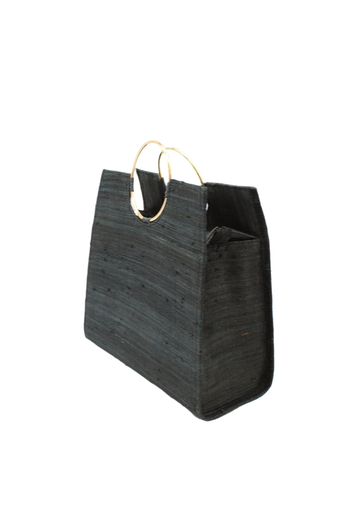 Side View JoJo Woven Straw Handbag with Metal Ring Handle handmade natural raffia palm fiber in a solid hue of black with matching woven thread texture and metallic circular metal ring handle - Shebobo