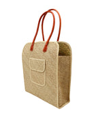 Side view Josephine 50's Inspired Woven Straw Handbag handmade natural raffia palm fiber in natural straw color woven with contrasting Cinnamon tobacco/dark/brown thread stitching in a subtle diagonal stripe pattern consisting of bands of ovals and circles with loomed raffia edging around the bag as well as the pocket and flap of the exterior pocket - Shebobo