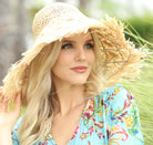 Model wearing Karin Crochet & Macrame Natural Raffia Knotted Straw Sun Hat Lightweight Breathable with Fringe Edge geometric star or sunburst design brim and geometric diamond pattern top - Shebobo