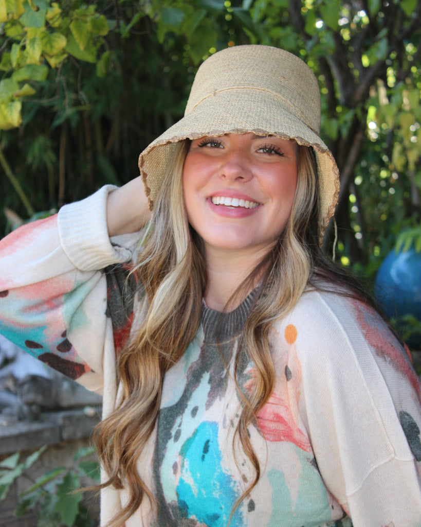 Model wearing Kate Natural with Cappuccino Crochet Bucket Straw Hats with Colored Lace Weave Edge handmade woven raffia palm fiber in a solid hue of natural straw color in a subtle link texture with cappuccino tea/light/brown lace weave floral edge trim around the outer brim two tone multicolor uv protection hat - Shebobo