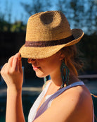 Model wearing Kelly Crochet Fedora - Unisex Straw Sun Hats handmade woven natural raffia palm fiber in a solid hue of natural straw color with woven in hatband of  cinnamon/tobacco/brown - Shebobo