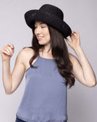 Model wearing Leor Black crochet straw hat handmade woven natural raffia palm fiber in a solid hue of black raffia 3" brim packable straw hat with matching adjustable braided hat band - Shebobo