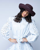 Model wearing Leor Mocha crochet straw hat handmade woven natural raffia palm fiber in a solid hue of mocha chocolate/dark/brown raffia 3" brim packable straw hat with matching adjustable braided hat band - Shebobo
