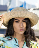Model wearing 3 inch brim Leor natural crochet straw hat packable lightweight adjustable beach hat - Shebobo