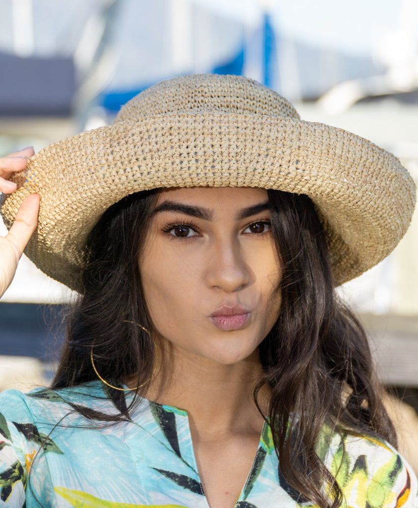 Model wearing 3 inch brim Leor natural crochet straw hat packable lightweight adjustable beach hat - Shebobo
