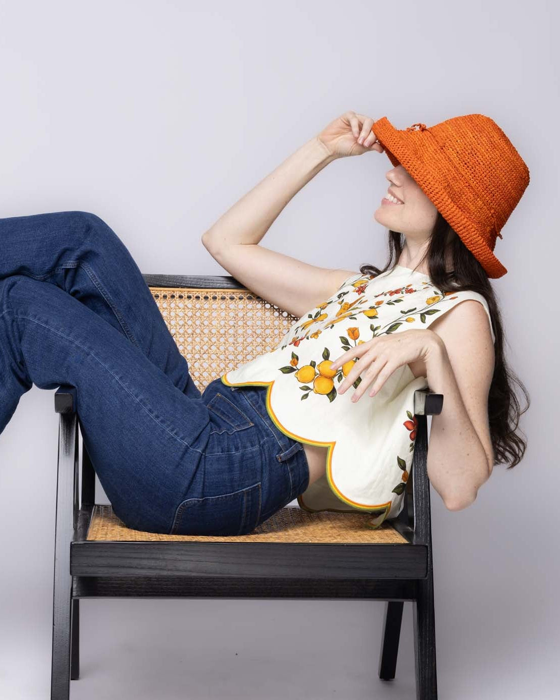 Model wearing Leor Sunkist crochet straw hat handmade woven natural raffia palm fiber in a solid hue of Sunkist ora raffia 3" brim packable straw hat with matching adjustable braided hat band - Shebobo