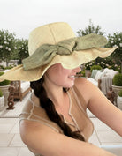 Model wearing Lilly 5" Brim Fan Straw Sun Hat with Big Ocean Mist/sage/green bow and matching hatband on handmade natural loomed raffia pleated wide brim hat - Shebobo