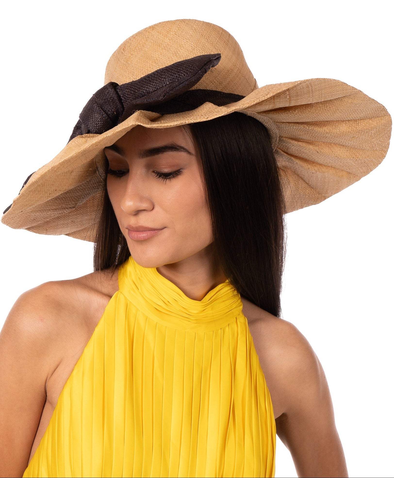 Model wearing Lilly 5" Brim Fan Straw Sun Hat with Big Black bow and matching hatband on handmade natural loomed raffia pleated wide brim hat - Shebobo