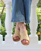 Model wearing Lizzie Crochet Straw & Leather Sandal handmade crochet natural raffia palm fiber in a solid hue of natural straw color in a h-shape double band across the top of the shoe and leather soles summer slide shoe - Shebobo