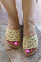 Model wearing Lulu Macrame and Crochet Diamond Straw Sandal Shoes handmade natural raffia palm fiber crochet and knotted macrame in a solid hue of natural straw color with geometric diamond or flower pattern in diagonal bands of texture on the top of the shoe and leather with rubber anti slip soles slide sandals - Shebobo