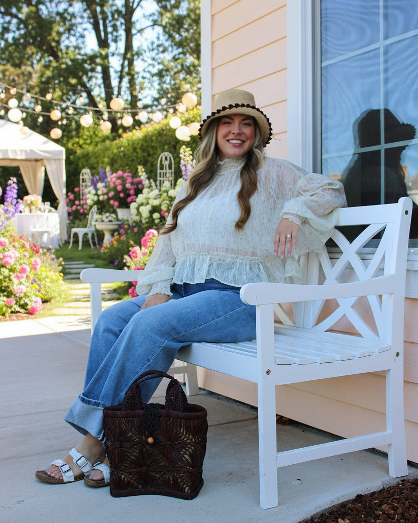 Model wearing Small size Lusha Macrame Diamond and Crochet Straw Basket Bag handmade natural raffia palm fiber in a solid hue of umberwine bordeaux/burgundy/claret/dark/purple/red macrame into a large geometric diagonal diamond pattern with loop banding on the top and bottom edges, macrame diamond and loop handles, with knotted matching flap closure beach bag shoulder bag purse - Shebobo (with Cara 3" Brim Bucket Straw Sun Hats with Big Bow)
