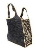 Side view Mamie Zigzag Pinstripe XL Crochet Straw Basket Handbag handmade crochet natural raffia palm fiber in a solid hue of black purse beach bag with contrasting natural straw color zigzag pinstripe pattern on the sides of the bag and matching outer edge - Shebobo