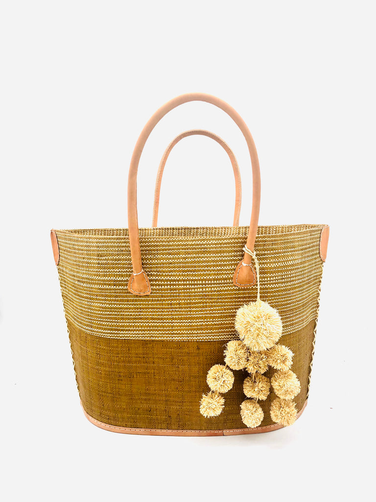 Manhattan Melange Two Tones Cinnamon Tote Bag with Waterfall Pompoms handmade loomed raffia in a color block design with the top half in a Cinnamon/Tobacco/Brown and natural melange horizontal heathered pattern and the bottom half solid color plus natural colored charm embellishment - Shebobo