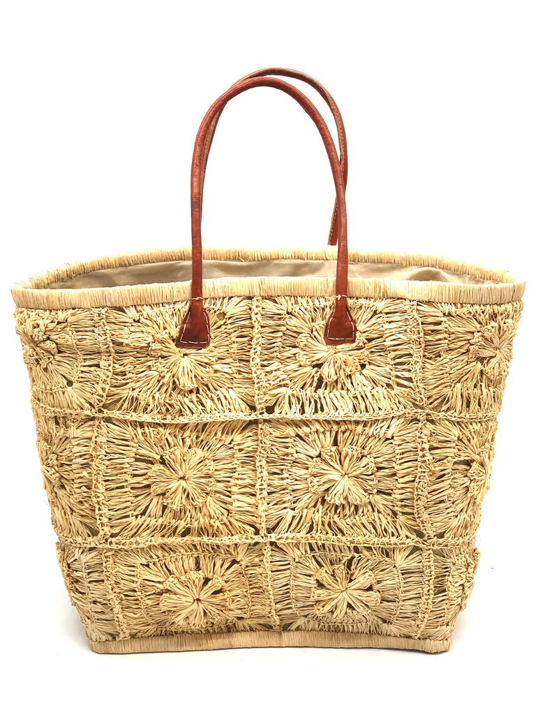 Marie Flower Crochet Straw Basket Bag handmade natural raffia palm fiber woven into a geometric grid of squares with a central flower per square similar to a granny square pattern handbag tote with leather handles - Shebobo