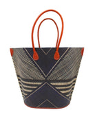 Mariposa Large Straw Tote Bag handmade loomed natural raffia palm fiber in a multi paneled pattern design of pinstripe, melange, and wide stripe combinations geometrically radiating from the center point of the bag outwards in a two tone color combination of Black and natural straw color with a solid hue of color on the back of the bag plus leather handles and embellishments shoulder bag - Shebobo