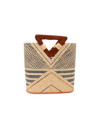 Mariposa Zuki Raffia Straw Bucket Handbag with Wood Triangle Handles  handmade loomed raffia palm fiber in a multi paneled pattern design of pinstripe, melange, and wide stripe combinations geometrically radiating from the center point of the bag outwards in a two tone color combination of Natural straw color and black with a solid hue of color on the back of the bag plus carved wooden handles purse - Shebobo